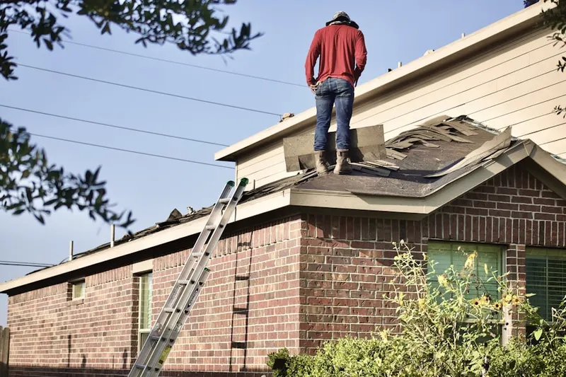 Professional roofer working on a residential roof in Norman